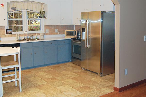3 Falls Road Sturbridge, MA 01566 - Photo 9 of 28 a kitchen with stainless steel appliances a refrigerator and cabinets
