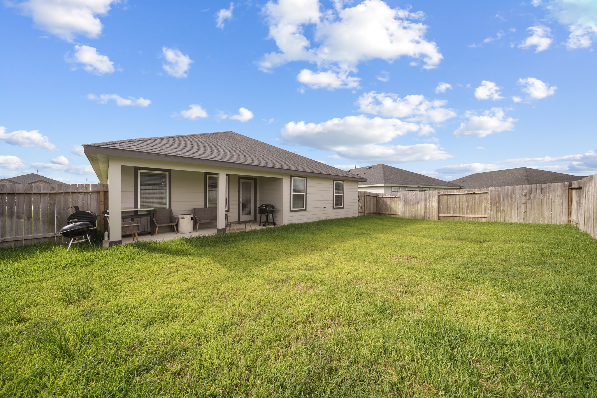 8918 Century Plant Lane Rosharon, TX 77583 - Photo 19 of 19 Spacious, fully fenced backyard with a covered patio and plenty of open lawn space.