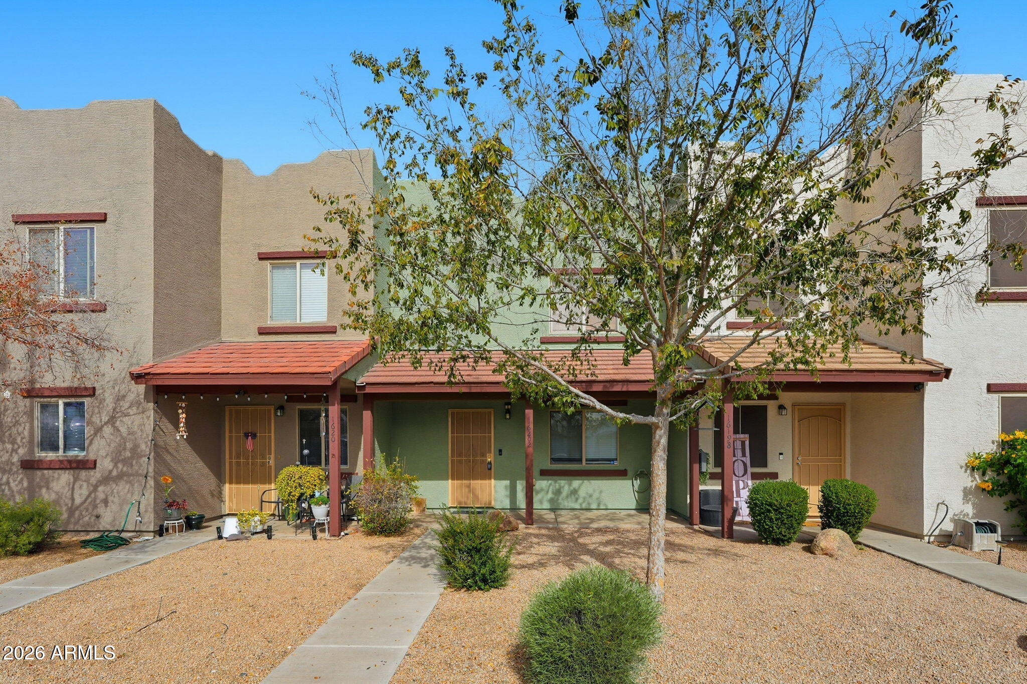 16202 North Desert Sage Street Surprise, AZ 85378 - Photo 1 of 25 a front view of a house with a garden