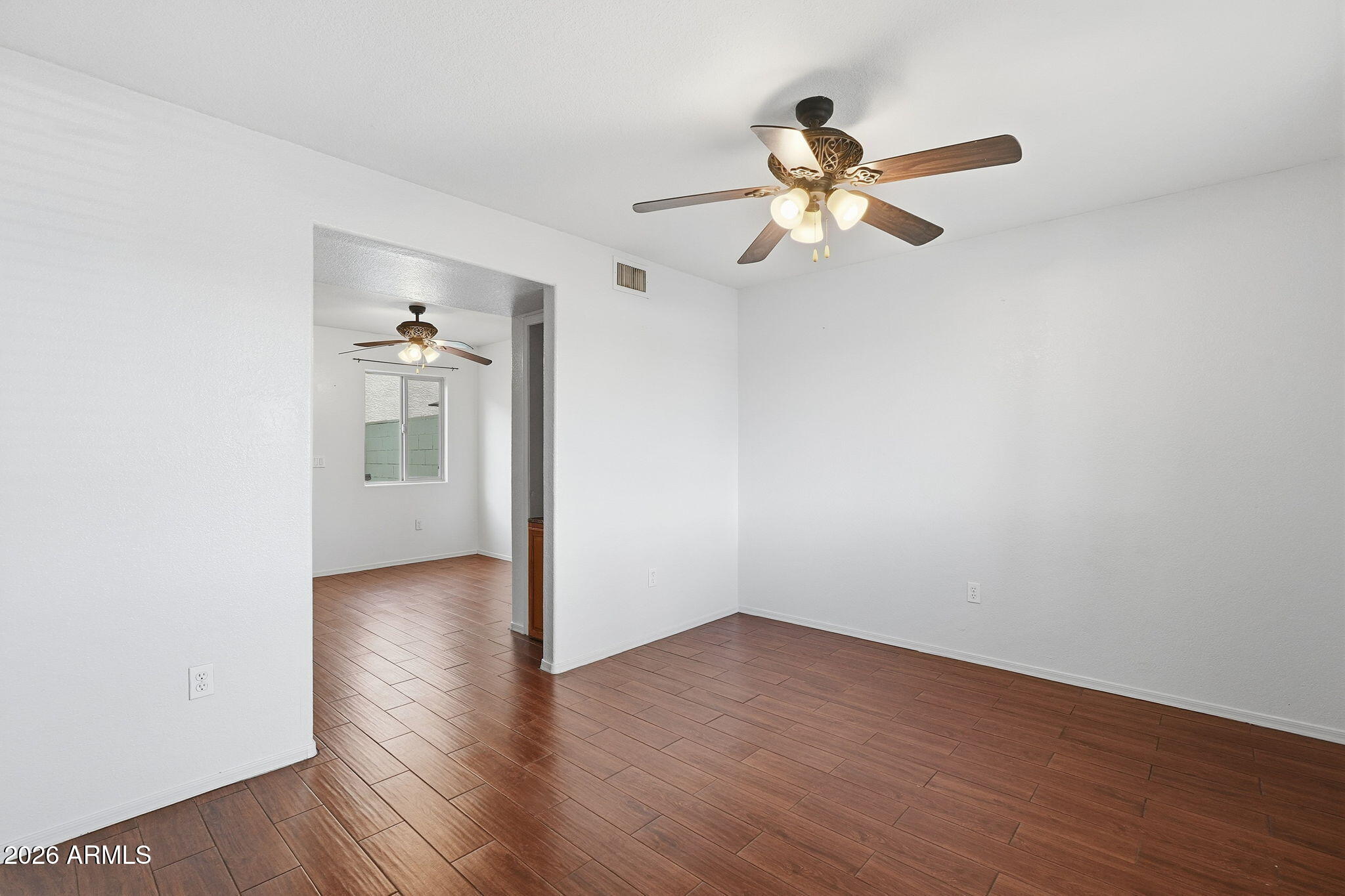 16202 North Desert Sage Street Surprise, AZ 85378 - Photo 12 of 25 a view of a room with wooden floor ceiling fan