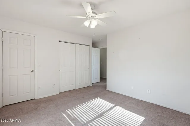 an empty room with fan and a ceiling fan