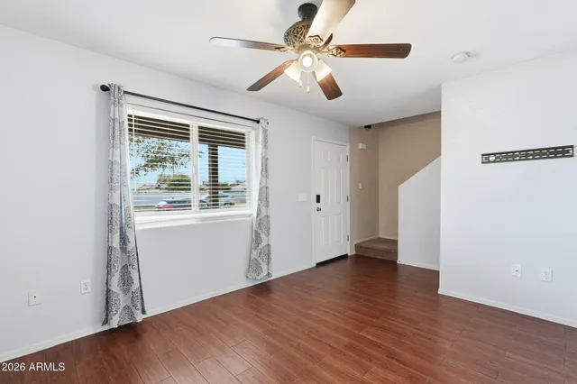 wooden floor in an empty room with a window