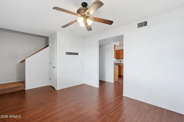 a view of an empty room with wooden floor