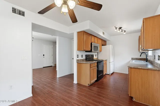 a kitchen with stainless steel appliances a stove top oven a sink and dishwasher