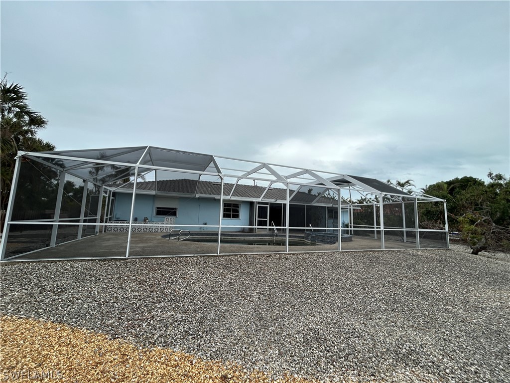 740 Windlass Way Sanibel, FL 33957 - Photo 18 of 22 an outdoor space with wooden fence and large trees