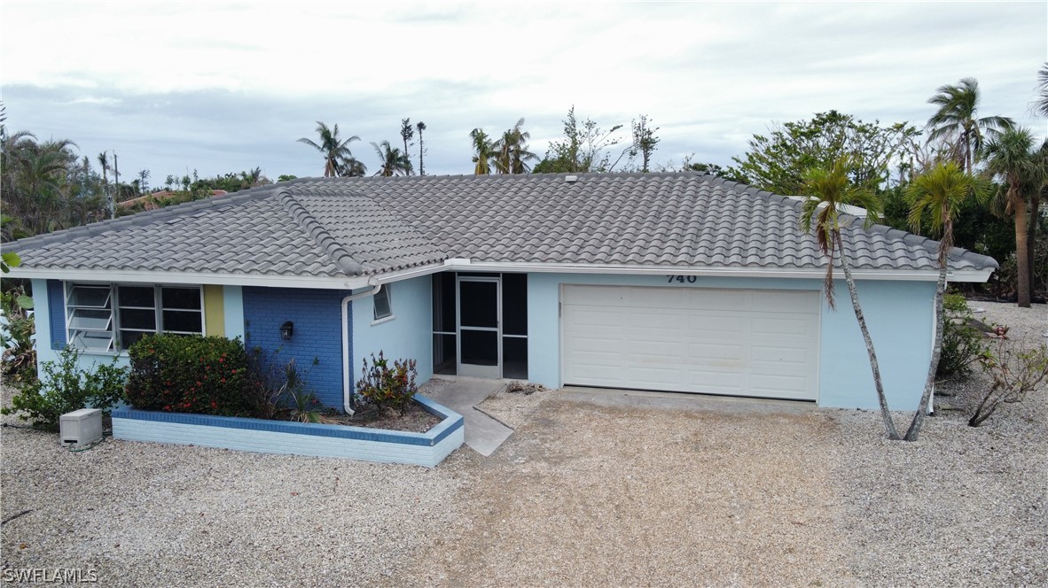 740 Windlass Way Sanibel, FL 33957 - Photo 5 of 22 a front view of a house with garden
