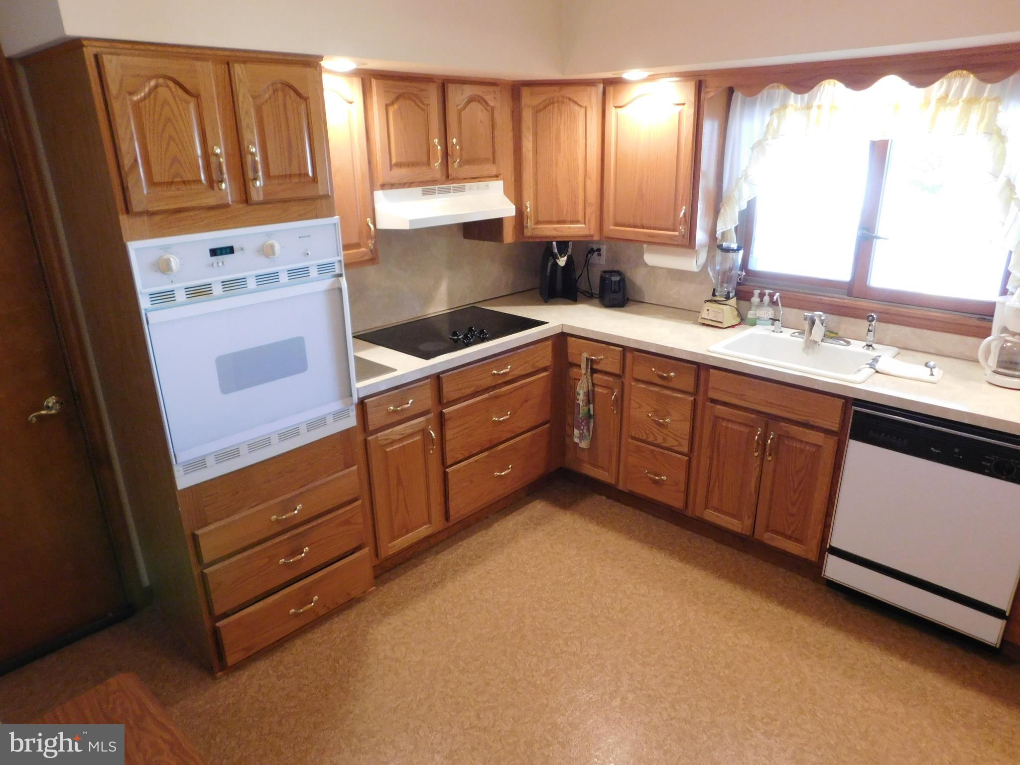 150 East Ruddle Street Coaldale, PA 18218 - Photo 5 of 12 a kitchen with stainless steel appliances granite countertop a refrigerator a sink and white cabinets