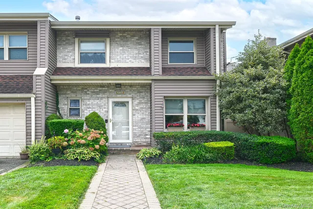 a front view of a house with garden