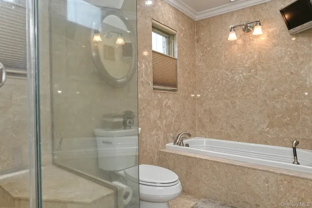 a living room with furniture a rug and a bookshelf