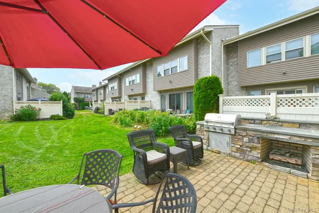 a view of a house with backyard porch and furniture