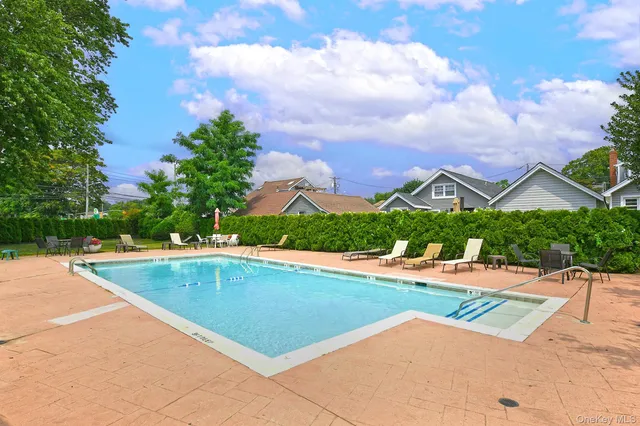 a view of a patio with table and chairs potted plants and a palm tree