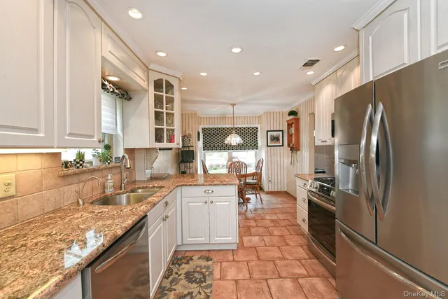 a kitchen with a appliances dining table and chairs