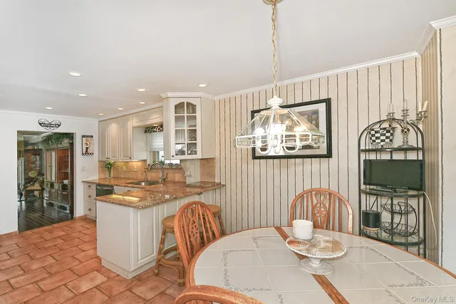 a kitchen with stainless steel appliances kitchen island granite countertop a refrigerator and a stove top oven