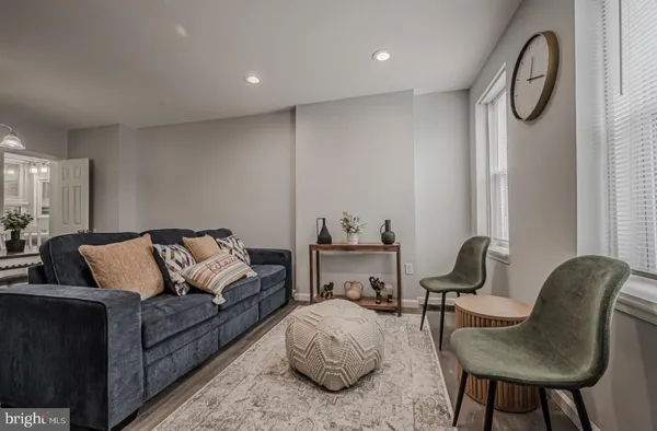 a living room with furniture a rug and a chair