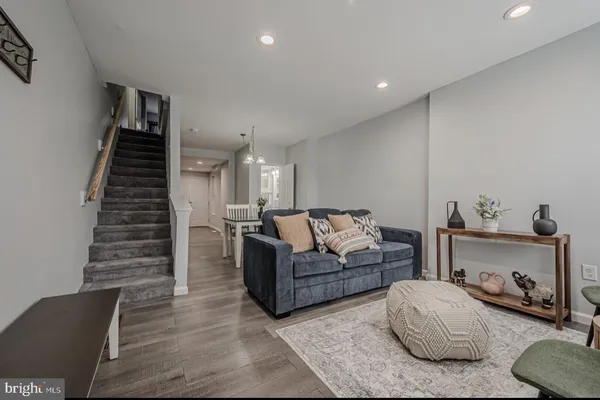 a living room with furniture and a stairs