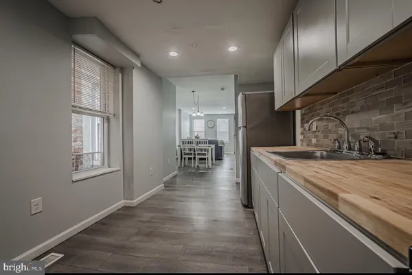 a kitchen with granite countertop cabinets stainless steel appliances a sink and a window