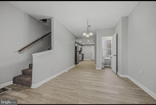 a view of a big room with entryway and stairs