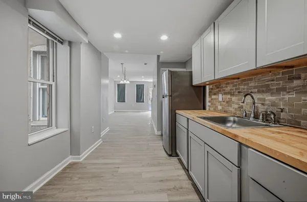 a kitchen with stainless steel appliances granite countertop a refrigerator and a sink
