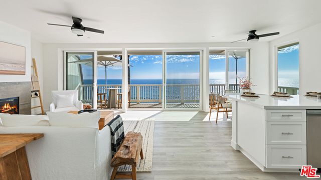 a very nice looking living room with a large window and furniture