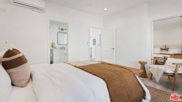 a bathroom with a sink a toilet and a large mirror