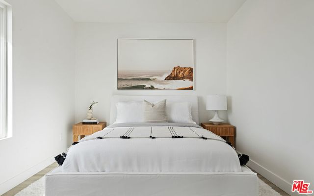 a living room with a bed and a window