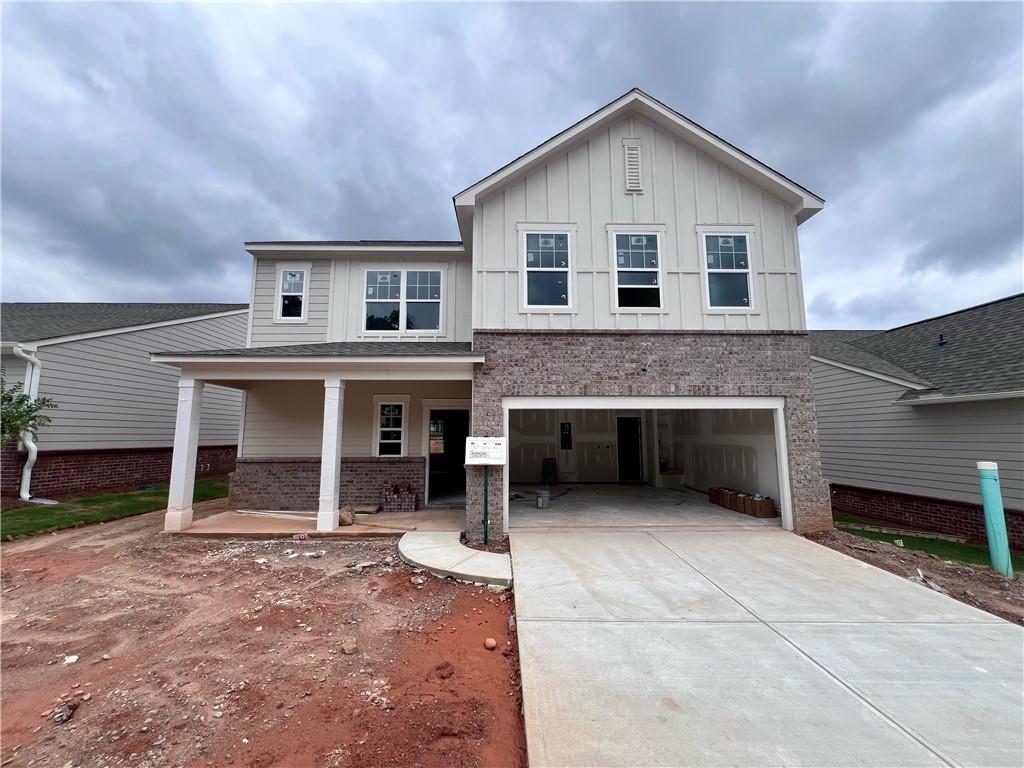 7565 Saffron Avenue Covington, GA 30014 - Photo 1 of 1 a front view of a house with a yard and garage
