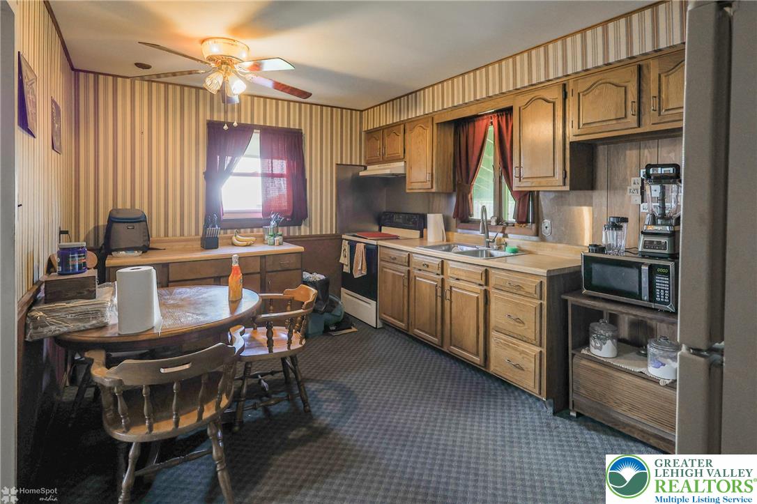 1336 Greenview Drive Bethlehem, PA 18018 - Photo 17 of 58 a kitchen with a sink a stove and chairs