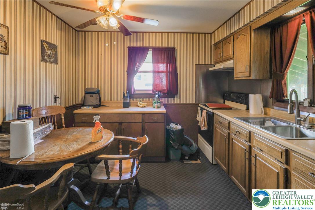 1336 Greenview Drive Bethlehem, PA 18018 - Photo 18 of 58 a kitchen with sink a window and chairs