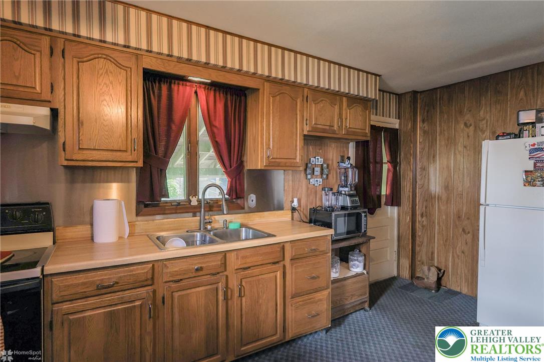 1336 Greenview Drive Bethlehem, PA 18018 - Photo 22 of 58 a kitchen with a sink window and cabinets