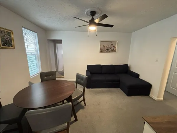 a living room with furniture window and a couch