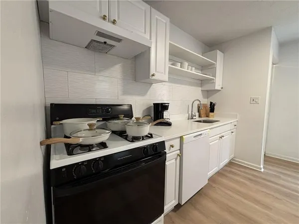 a kitchen with cabinets a sink and stove