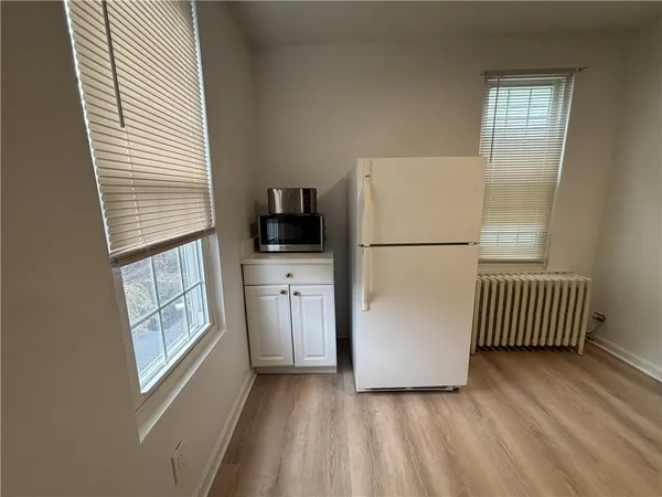 a view of kitchen with furniture and refrigerator