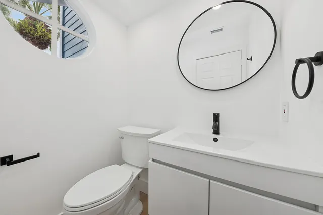 a bathroom with a sink a mirror and a toilet