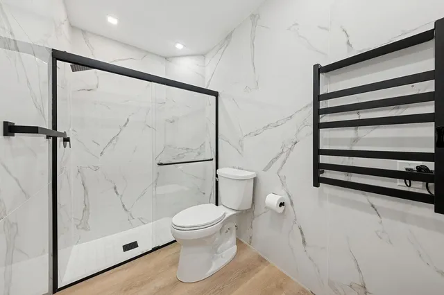 a bathroom with a toilet and a shower