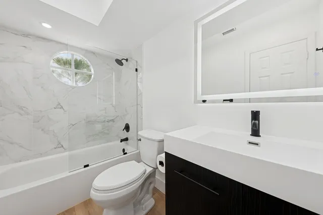 a bathroom with a sink a toilet and a bathtub