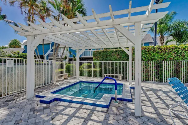 a view of a backyard with a deck and a garden