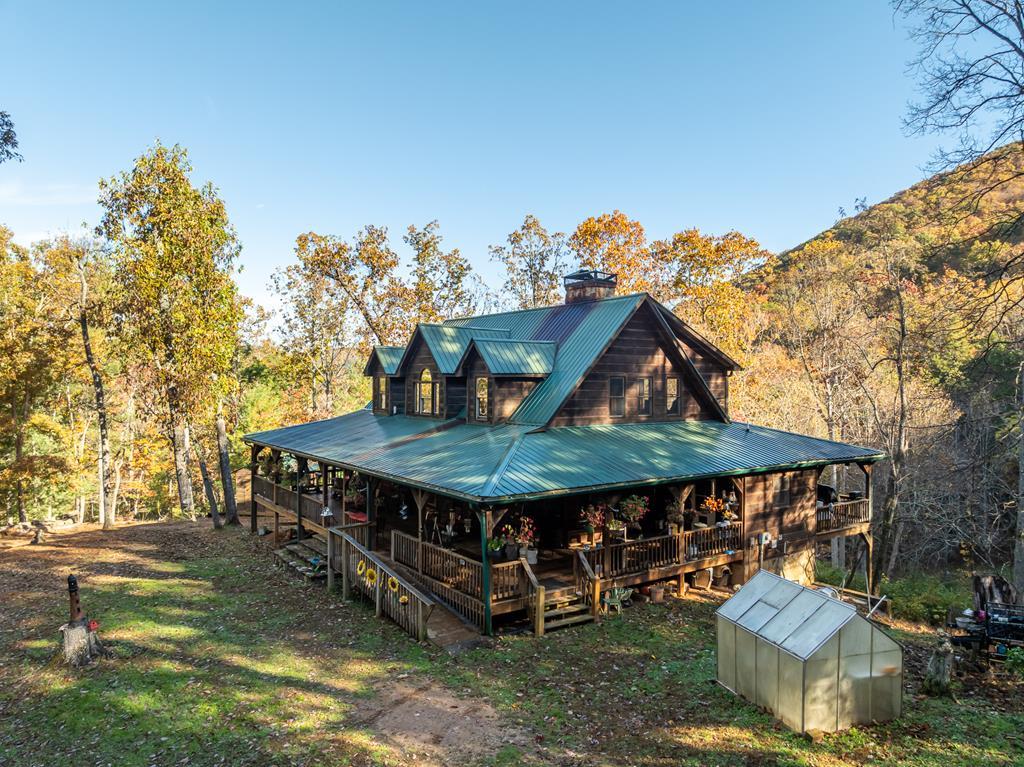 336 Old Skeenah Gap Road Suches, GA 30572 - Photo 2 of 81 a view of a backyard with couches chair and a fire pit