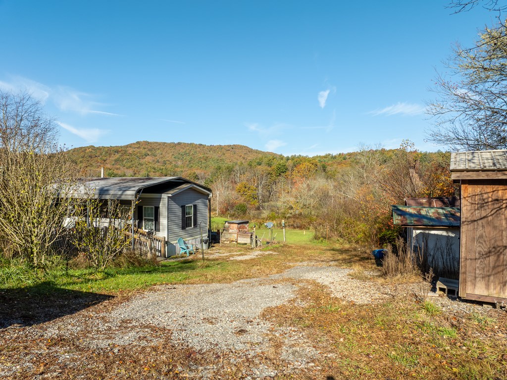 336 Old Skeenah Gap Road Suches, GA 30572 - Photo 29 of 81 a front view of a house with a yard and mountain view in back