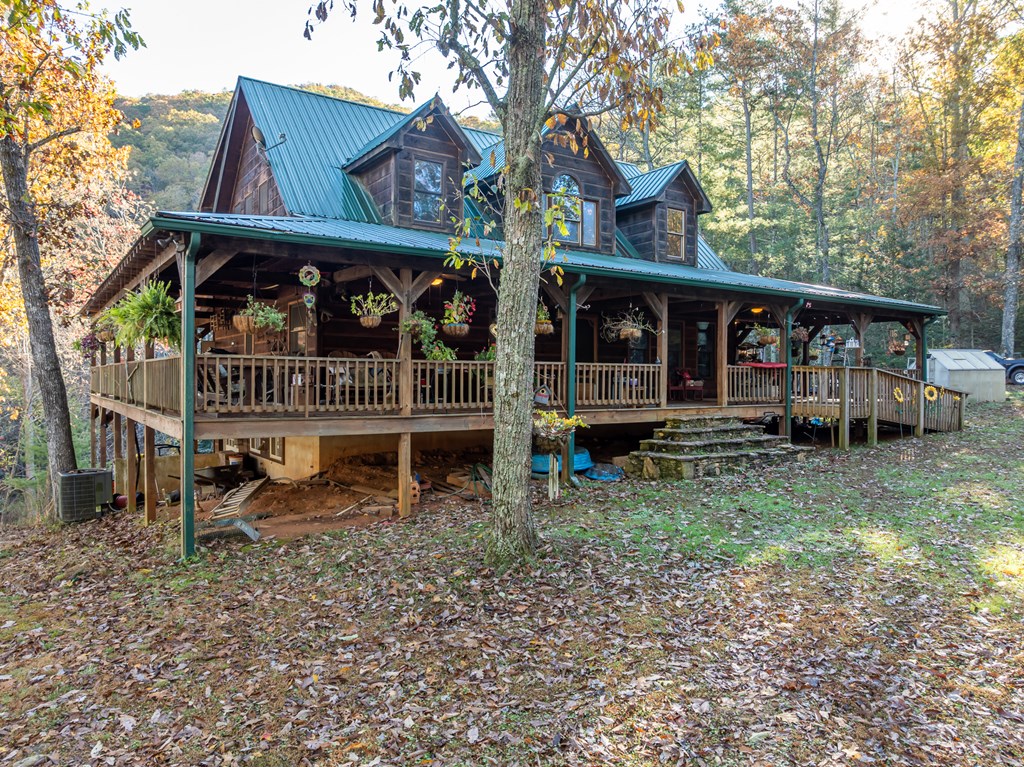 336 Old Skeenah Gap Road Suches, GA 30572 - Photo 3 of 81 a view of a house with a wooden deck and a forest