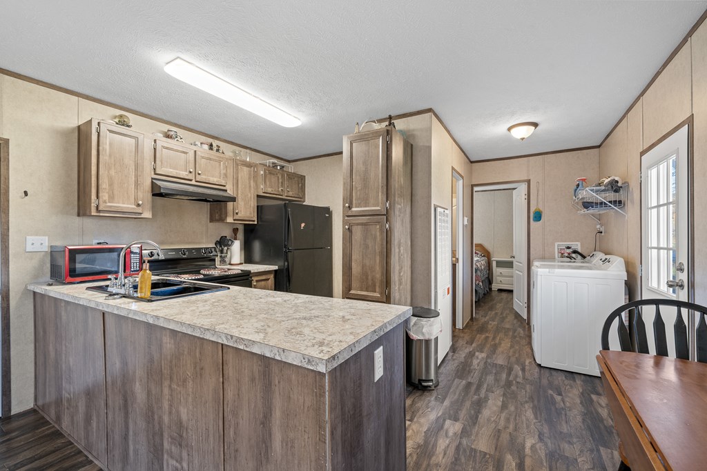 336 Old Skeenah Gap Road Suches, GA 30572 - Photo 35 of 81 a kitchen with a refrigerator a stove a sink dishwasher and wooden cabinets with wooden floor