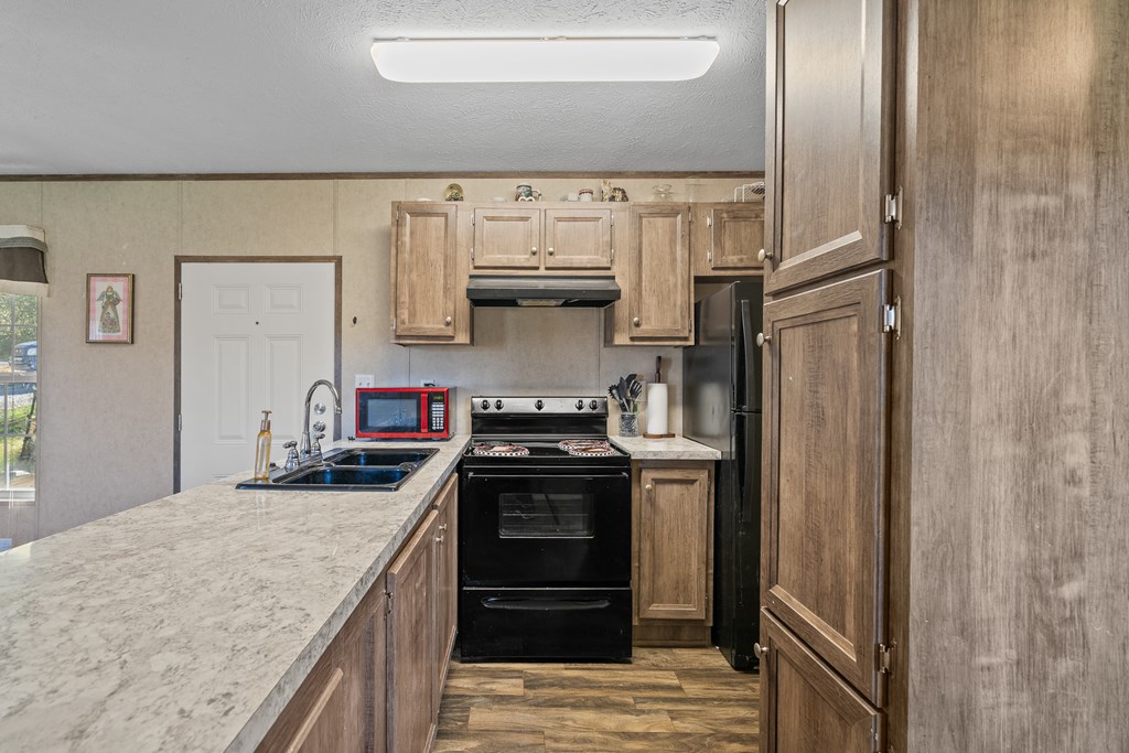 336 Old Skeenah Gap Road Suches, GA 30572 - Photo 36 of 81 a kitchen with stainless steel appliances granite countertop a stove and a refrigerator