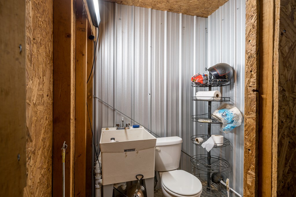 336 Old Skeenah Gap Road Suches, GA 30572 - Photo 44 of 81 a bathroom with a toilet and a shower curtain