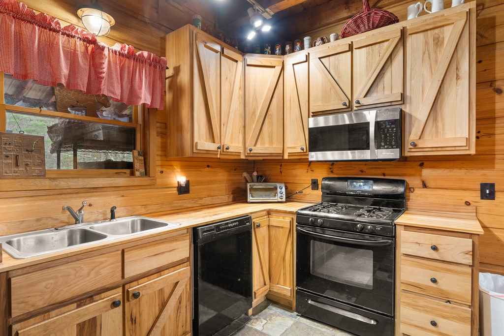 336 Old Skeenah Gap Road Suches, GA 30572 - Photo 60 of 81 a kitchen with a stove a sink and a microwave