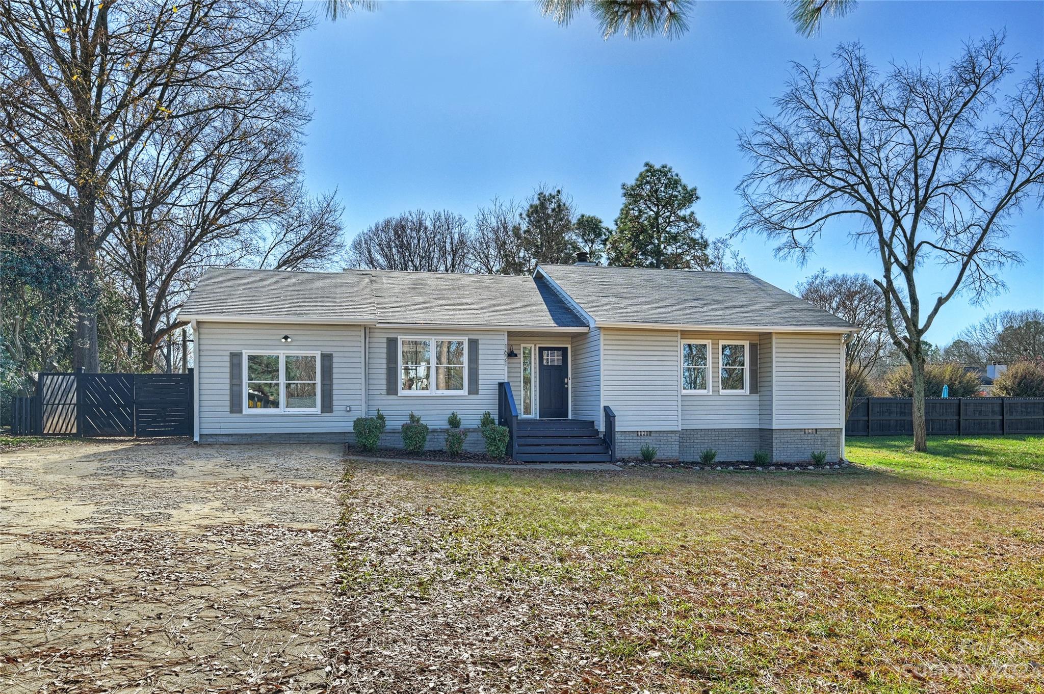 1621 Brook Drive Fort Mill, SC 29708 - Photo 1 of 30 a front view of a house with a garden and trees