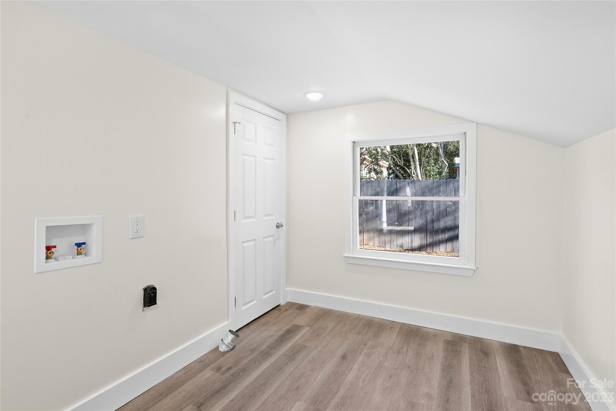 1621 Brook Drive Fort Mill, SC 29708 - Photo 23 of 30 an empty room with wooden floor and windows