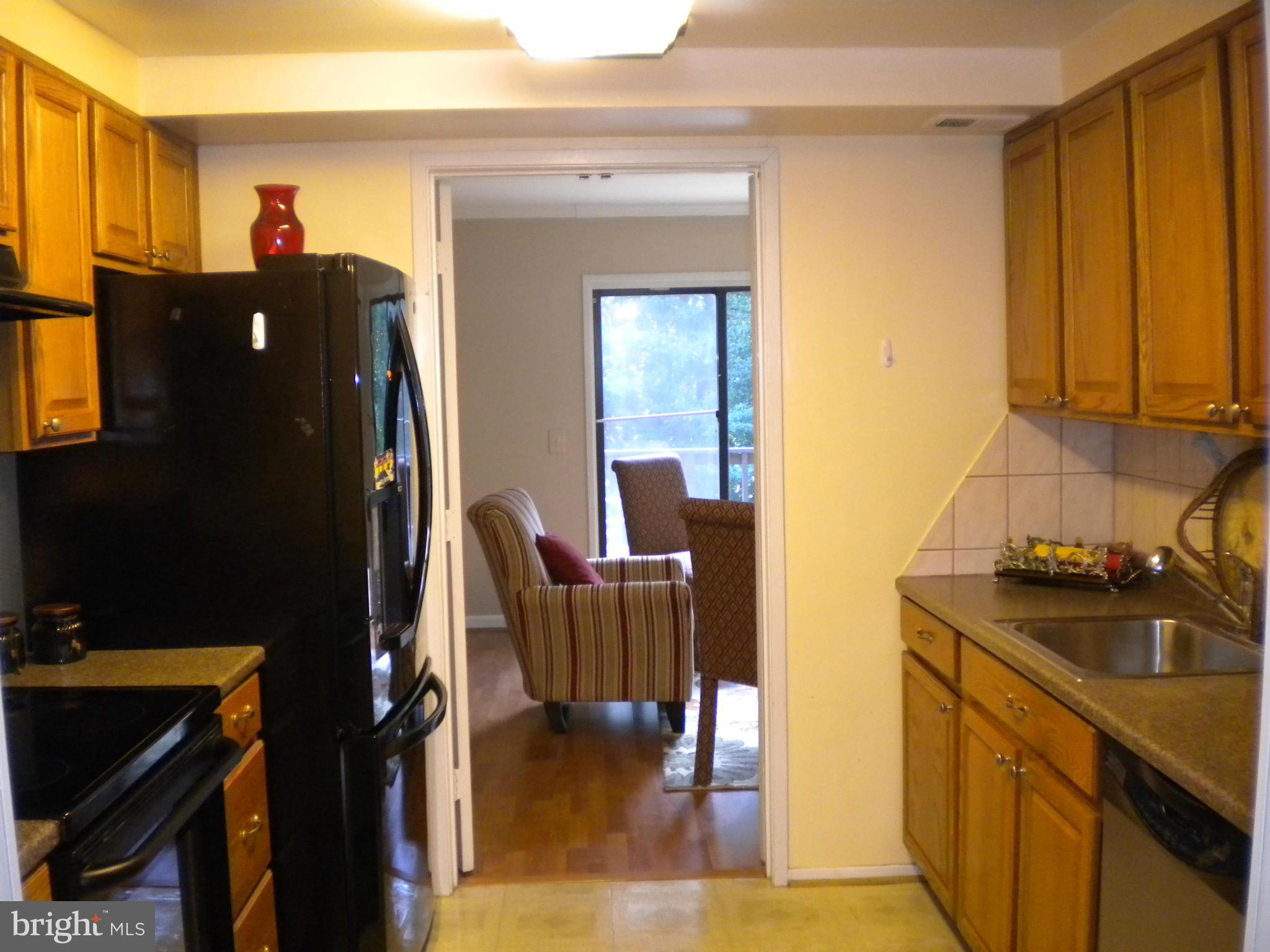 2266 Wheelwright Court Reston, VA 20191 - Photo 4 of 12 a kitchen with a refrigerator and a stove top oven