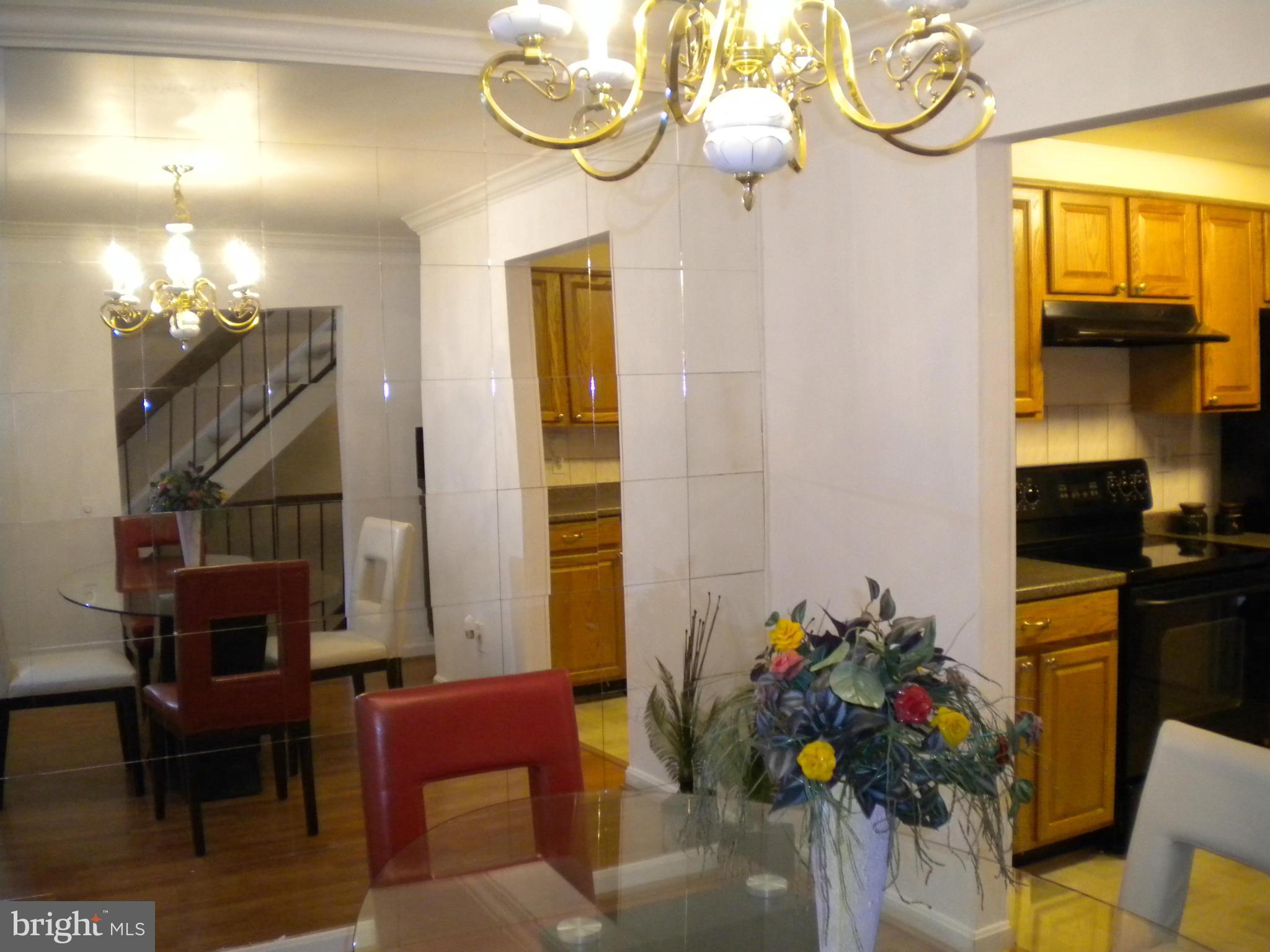 2266 Wheelwright Court Reston, VA 20191 - Photo 5 of 12 a view of a dining room with furniture a chandelier and wooden floor