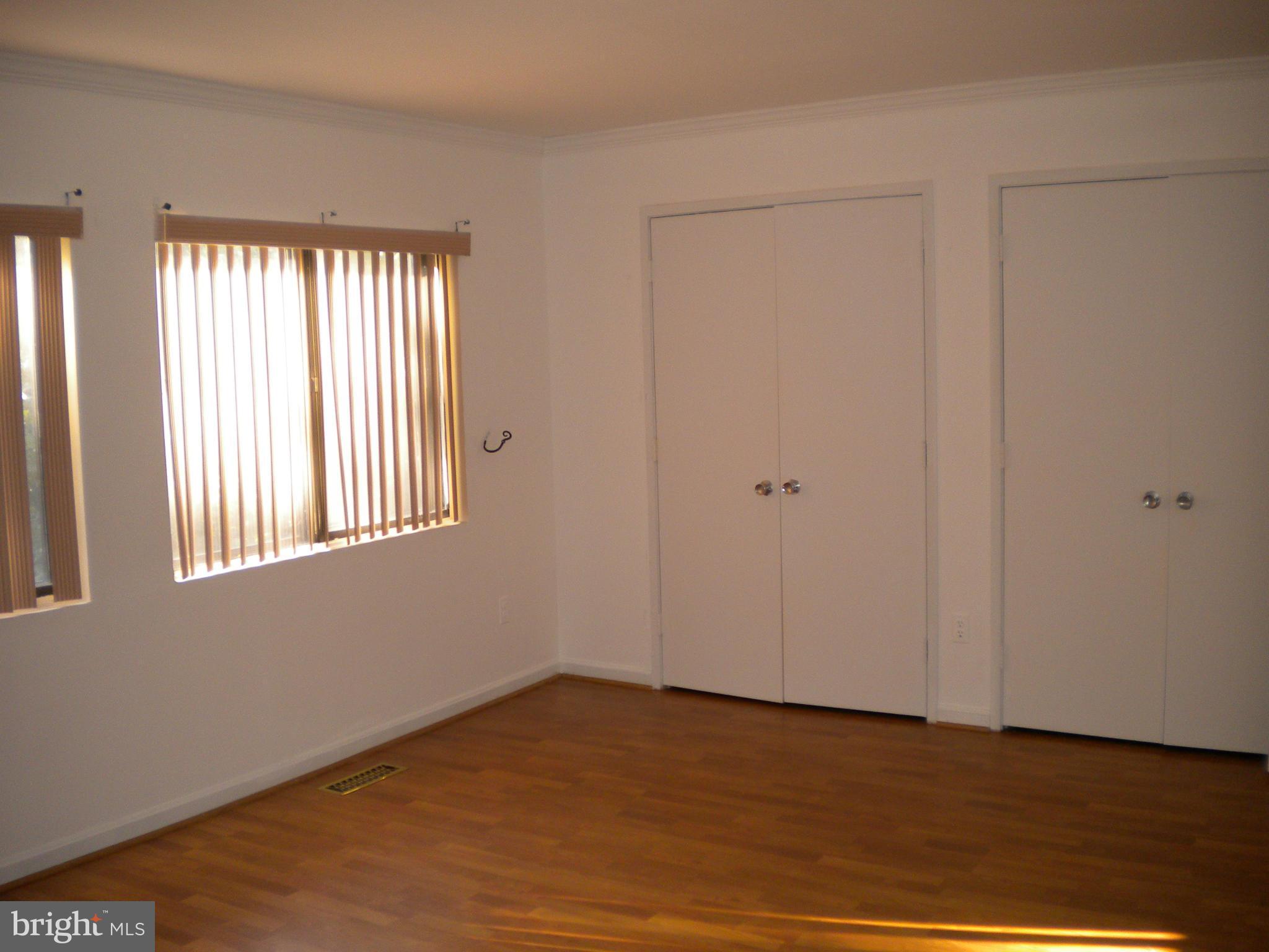 2266 Wheelwright Court Reston, VA 20191 - Photo 6 of 12 a view of an empty room with wooden floor and a window