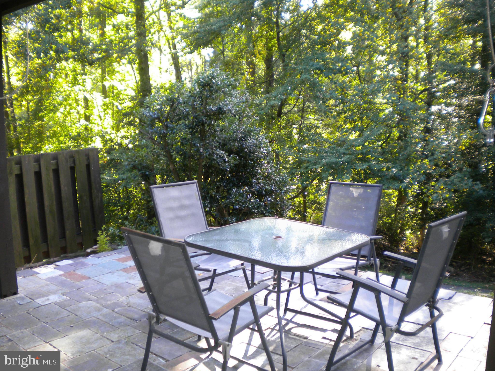 2266 Wheelwright Court Reston, VA 20191 - Photo 10 of 12 a backyard of a house with table and chairs