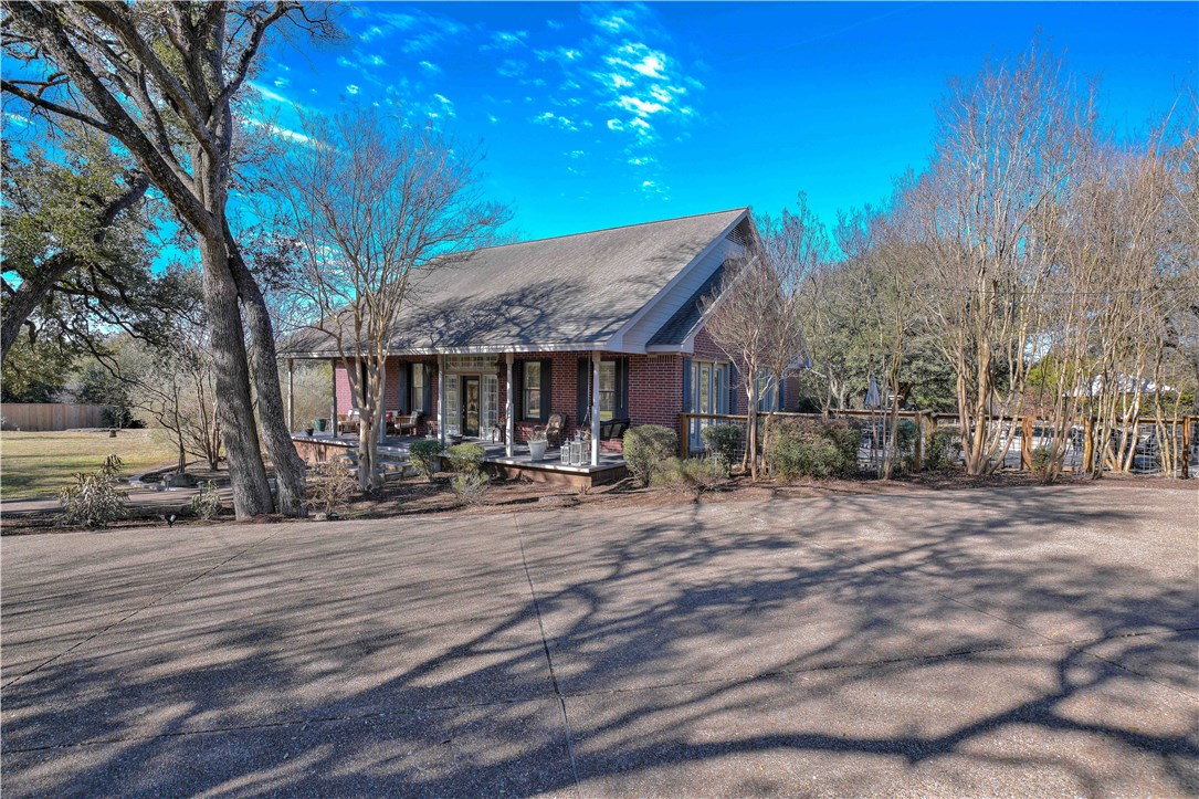 a view of a house with yard and sitting area